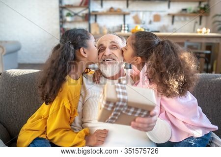 Two Dark-skinned Sisters Kissing Their Grandad And Giving Hime A Present