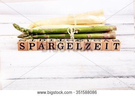 White And Green Asparagus On Background With Spargelzeit Wooden Letter.