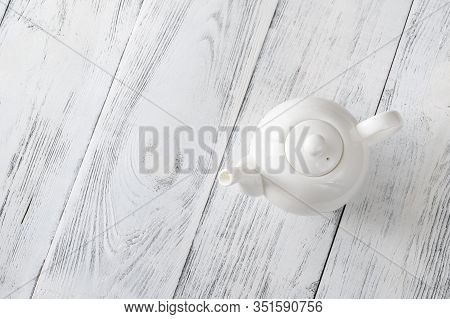 Porcelain Teapot With Tea On A Table