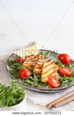 Fresh Salad With Grilled Halumi Cheese, Cherry Tomatoes And Arugula. Copy Space.