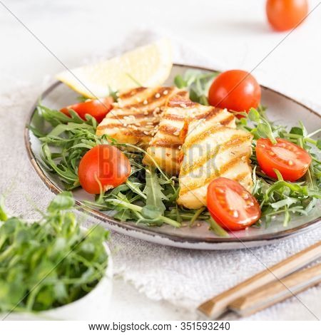 Fresh Salad With Grilled Halumi Cheese, Cherry Tomatoes And Arugula. Copy Space.