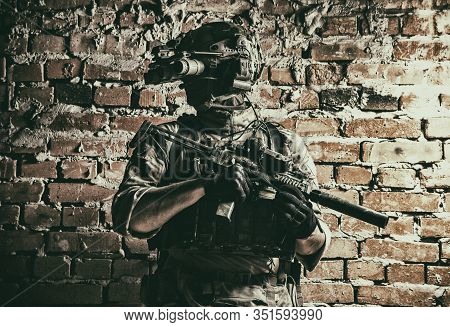 Army Special Forces Tactical Group Fighter In Cqb Mission, Using Radio Headset, Looking Through Four