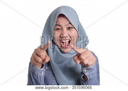 Portrait Of Muslim Lady Wearing Hijab Laughing Hard And Pointing Forward, Bully Expression, Close Up
