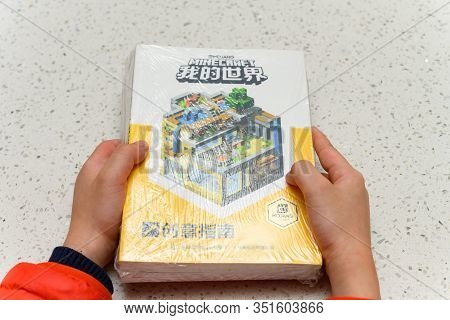 Zhongshan China-february 18,2020:kid Holding Set Of Books About The Minecraft.