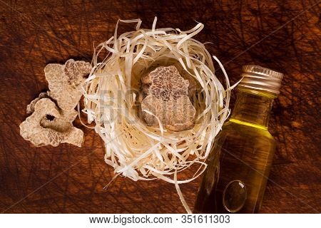 Original Italian White Truffle And Truffle Oil On Natural Background. Culinary Food Ingredient.