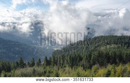 Black Forest Mountains Covered By Clouds And Fir Forest On A Spring Sunny Day, In Germany. Alpine La