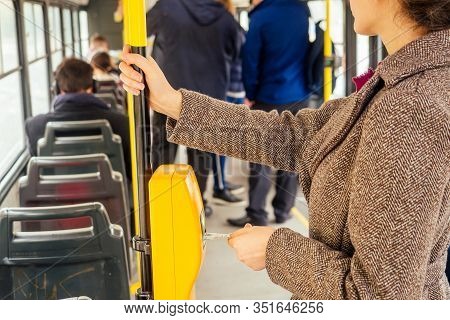 Young Woman Hand Inserts The Bus Ticket Into The Validator, Validating And Ticking In Prague Sity Ch