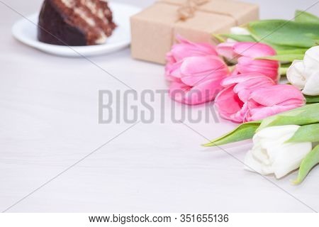 Bouquet Of Pink Tulips, Chocolate Cake. Pressent Box On White Wooden Background. Copy Space, Close U