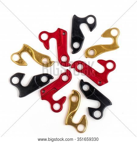 Laid Out Mandala-shaped Hangers For Derailleur Bike On White Background. Bicycle Frame Rear Deraille