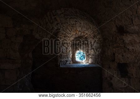 Textured Wall Of Ancient Fortress With Small Round Window.