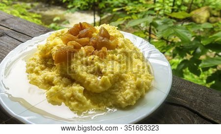 Traditional Porridge With Names Mamalyga, Hominy, Polenta, Banosh Or Kulesha On Nature Background.