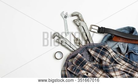 Set Of Metal Tools Near Checkered Shirt, Jeans, Leather Belt Top View. Mens Job Flat Lay Isolated On