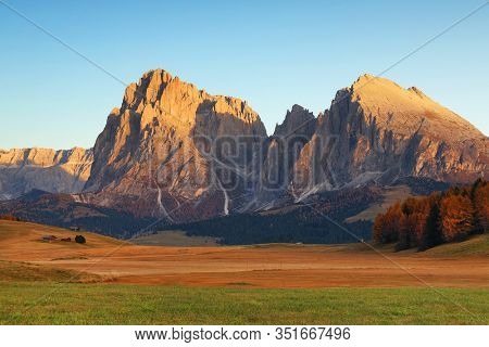 Autumn sunrise scenery with yellow larches in Alpe di Siusi (Seiser Alm) Dolomites, Italy, Europe