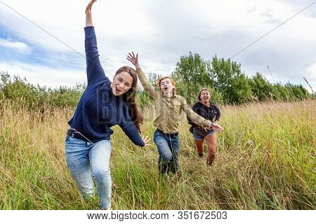 Summer Holidays Vacation Happy People Concept. Group Of Three Friends Boy And Two Girls Running And 