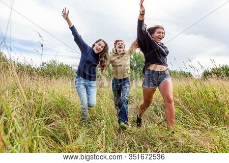 Summer Holidays Vacation Happy People Concept. Group Of Three Friends Boy And Two Girls Running And 