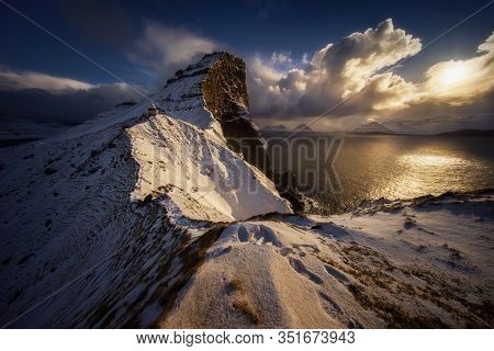 Kallur Lighthouse On Kalsoy Island With Borgarin Mountain Behind In Winter, Faroe Islands