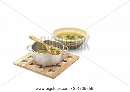 Homemade Italian Wedding Soup On A Wooden Spoon From The Pot Photographed On A White Background With