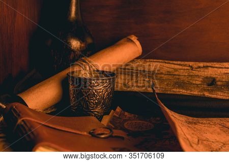 Old Plans Next To Other Elements In The Light Of Candles In Rustic Wood