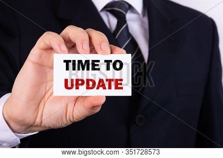 Businessman Holding A Card With Text Time To Update