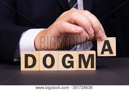 Man Made Word Dogma With Wood Blocks
