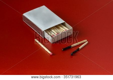 Matchbox And Two Burnt Matches On A Red Background. Open Full Matchbox. The Concept Is Another Chanc