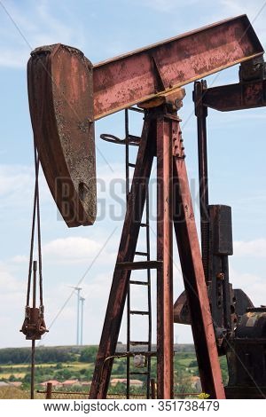 Oil well and windmills in Ayoluengo de la Lora, Burgo Province, Castilla Leon in Spain.