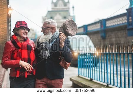 Happy Senior Couple Walking In London Near Tower Bridge - Mature Tourists Having Fun Discovering The
