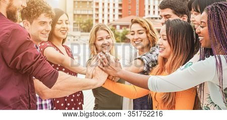 Young Happy People Stacking Hands Outdoor - Diverse Culture Students Celebrating Together - Youth Li