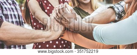 Young Happy People Stacking Hands Outdoor - Diverse Culture Students Celebrating Together - Youth Li