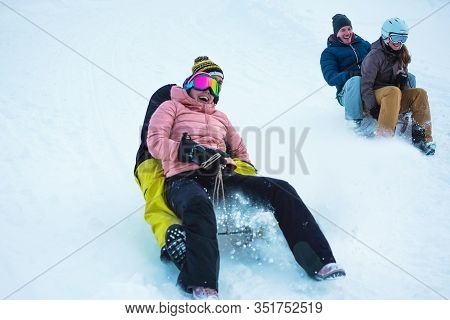 Crazy Happy Friends Having Fun With Sledding On Snow High Mountains - Young People Making Luge Compe