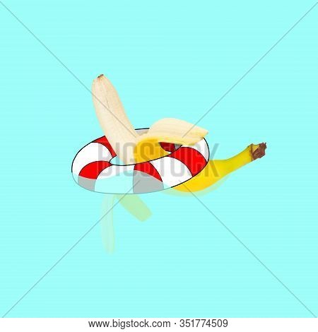 Banana Swimming In Swimring On Blue Water Pool Background. Copyspace For Your Proposal. Modern Desig