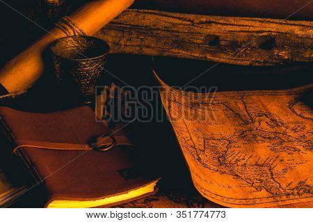Old Plans Next To Other Elements In The Light Of Candles In Rustic Wood