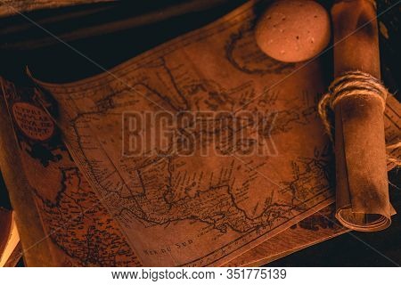 Old Plans Next To Other Elements In The Light Of Candles In Rustic Wood