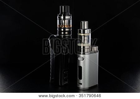 Electronic Cigarettes Or Vaping Devices On Black Background