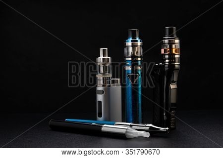 Electronic Cigarettes Or Vaping Devices On Black Background