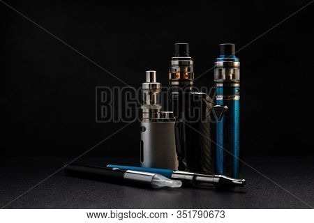 Electronic Cigarettes Or Vaping Devices On Black Background