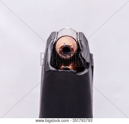 A Close Up Of A 9mm Pistol Magazine Loaded With 9mm Hollow Point Bullets On A White Background