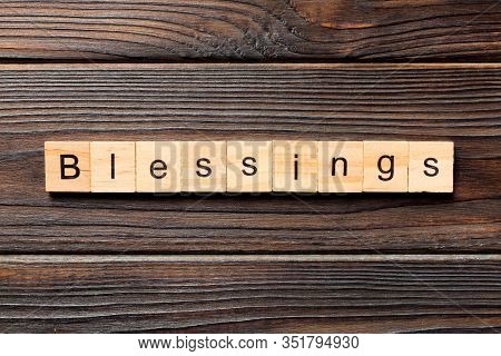 Blessings Word Written On Wood Block. Blessings Text On Wooden Table For Your Desing, Top View Conce