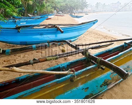 Beautiful Image Of Lots Of Blue Painted Fishing Boats On The Sandy Ocean Beach, Sri Lanka