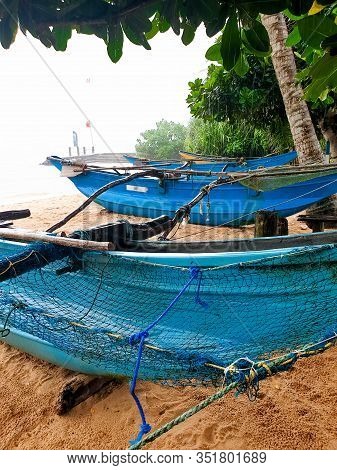 Beautiful Image Of Seasonal Rain Dorplets Falling On Old Fishing Wooden Boats Or Canoes On The Beach
