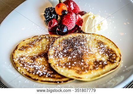 Pancake With Icing Sugar With Strawberry And Blueberrry Compote And Fresh Cream