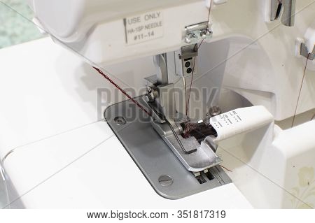 Sewing Machine For Wrapping Sections Of Textile Materials