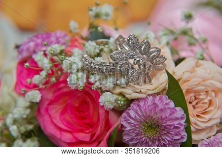 Close Up Wedding Ring On Top Of A Colorfull Bouquet. . Macro .close Up Of Wedding Rings On The Bouqu