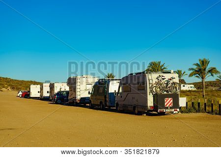 Percheles Beach, Spain - March 16, 2019: Camper Cars Camping On Mediterranean Coast With Palm Trees 