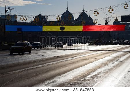 Bucharest, Romania - December 22, 2019: A Romanian Flag With A Hole In The Middle Is Displayed Near 