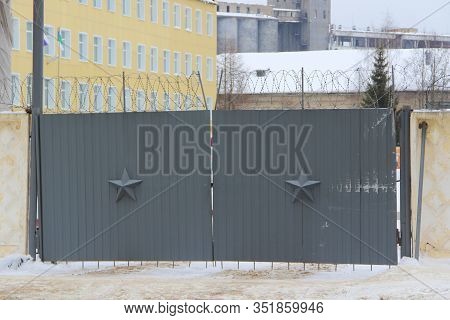 Dark Gray Walls Decorated With A Five-pointed Star And Barbed Wire. Stock Photo For Web And Print Wi
