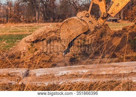 The Excavator Moves The Concrete Slabs To Set The Road In Private Territory.