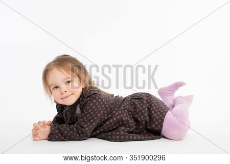 Close Up Portrait Of The Charming, Pretty Kid In Dress, Girl With Red Hair Liying On The Floor And L