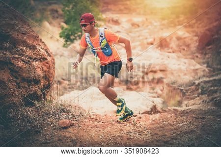 A Man Runner Of Trail And Athlete's Feet Wearing Sports Shoes For Trail Running In The Mountain