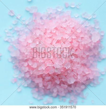 Heap Of Large Sprinkled Crystals Of Pink Sea Salt Closeup On A Blue Background With Place For Text. 
